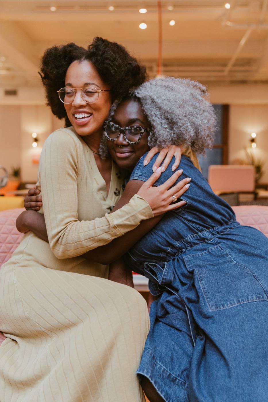 Lauren Ash embracing a community member at a gathering.